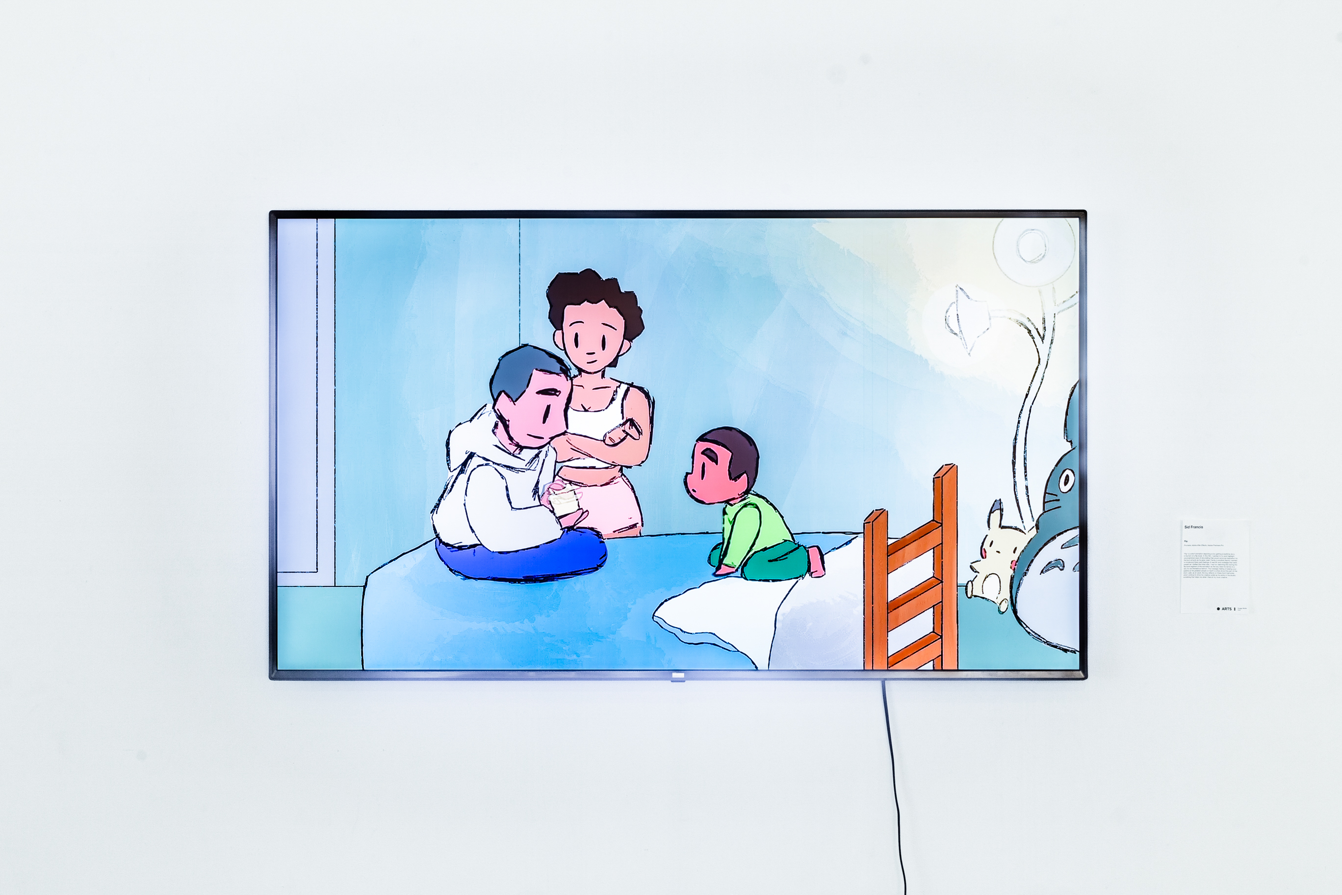 A cartoon illustration displayed on a tv of a young boy on a bed with his parents talking to him. The TV is hung on a white wall.